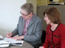 ARRL President Kay Craigie, N3KN, signs the new Memorandum of Understanding with the American Red Cross as American Red Cross President and CEO Gail McGovern looks on. [Michael Halston, ARC, Photo] 