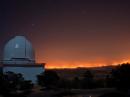 McDonald Observatory -- located atop Mount Locke and Mount Fowlkes in the Davis Mountains above Fort Davis -- overlooked the fire. Here, the fire is seen on April 9 to the east from the catwalk of the Observatory's 2.1 meter (82 inch) Otto Struve Telescope. The 2.7 meter (107 inch)  Harlan J. Smith Telescope is on the left. [Frank Cianiolo/McDonald Observatory, Photo]