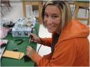 A teacher attending the ARRL Teachers Institute this past May in Roswell, New Mexico assembles her BOE-BOT. [Dan Musgrave, WD8RMG, Photo]