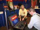 ARRL Emergency Preparedness and Response Manager Dennis Dura, K2DCD (left), shows John Ronan, EI7IG, a Ham Aid VHF Go Kit at the 2007 ARRL National Convention in Huntsville, Alabama. [S. Khrystyne Keane, K1SFA, Photo]