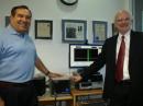 ARRL Chief Executive Officer David Sumner, K1ZZ (right), accepts the donation of a FLEX 5000A software defined radio from FlexRadio Systems John Basilotto, W5GI. The new radio will be available for visitors to use at W1AW. [S. Khrystyne Keane, K1SFA, Photo]